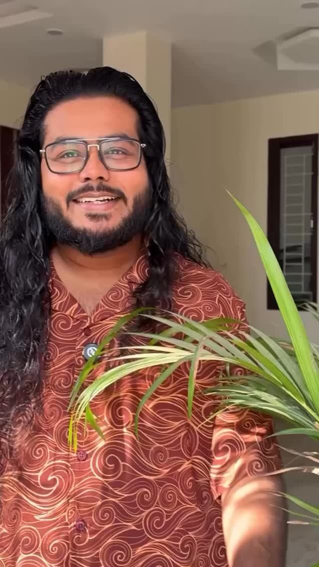 Akio smiling beside a green plant in a promo for Skinn by Titan Raw