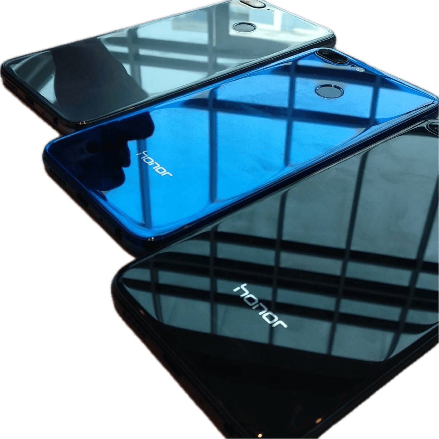 Honor 9 Lite smartphones with glossy glass backs laid on a table