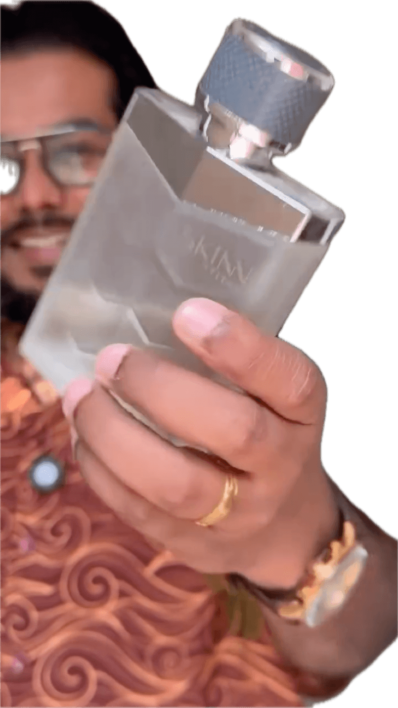 Akio smiling beside a green plant in a promo for Skinn by Titan Raw