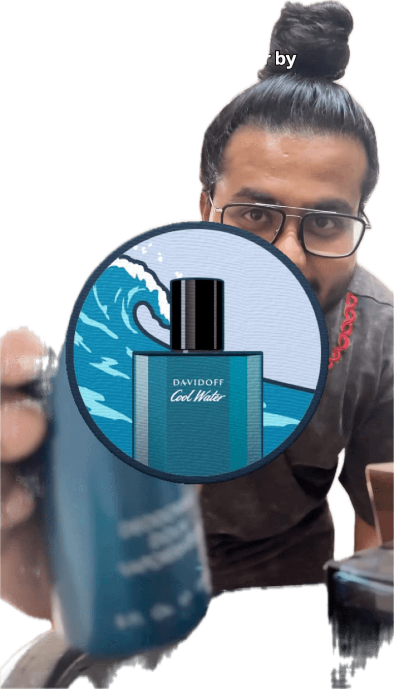 Akio holding a blue bottle of Davidoff Cool Water perfume