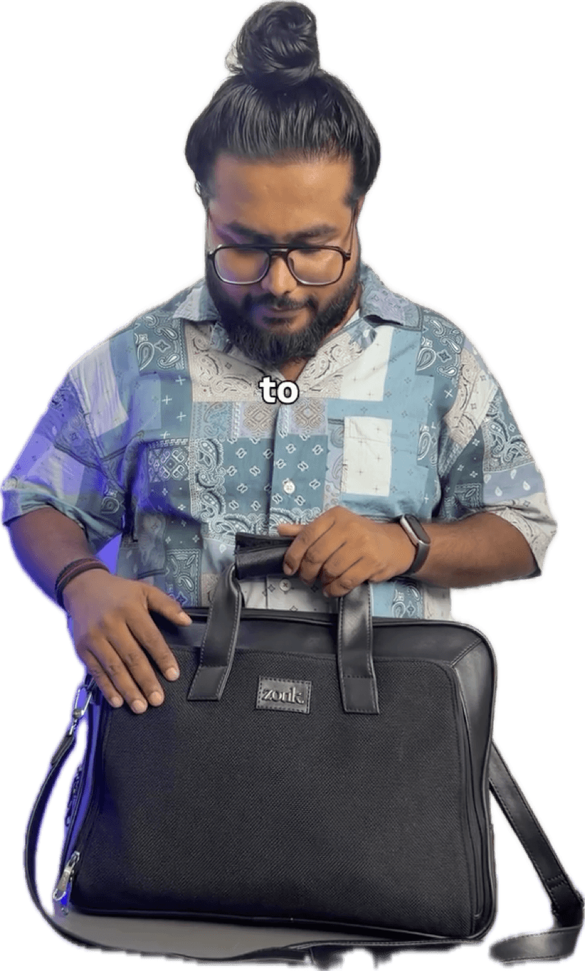 A black Zouk Executive Laptop Bag with leather handles resting on a cream leather car seat