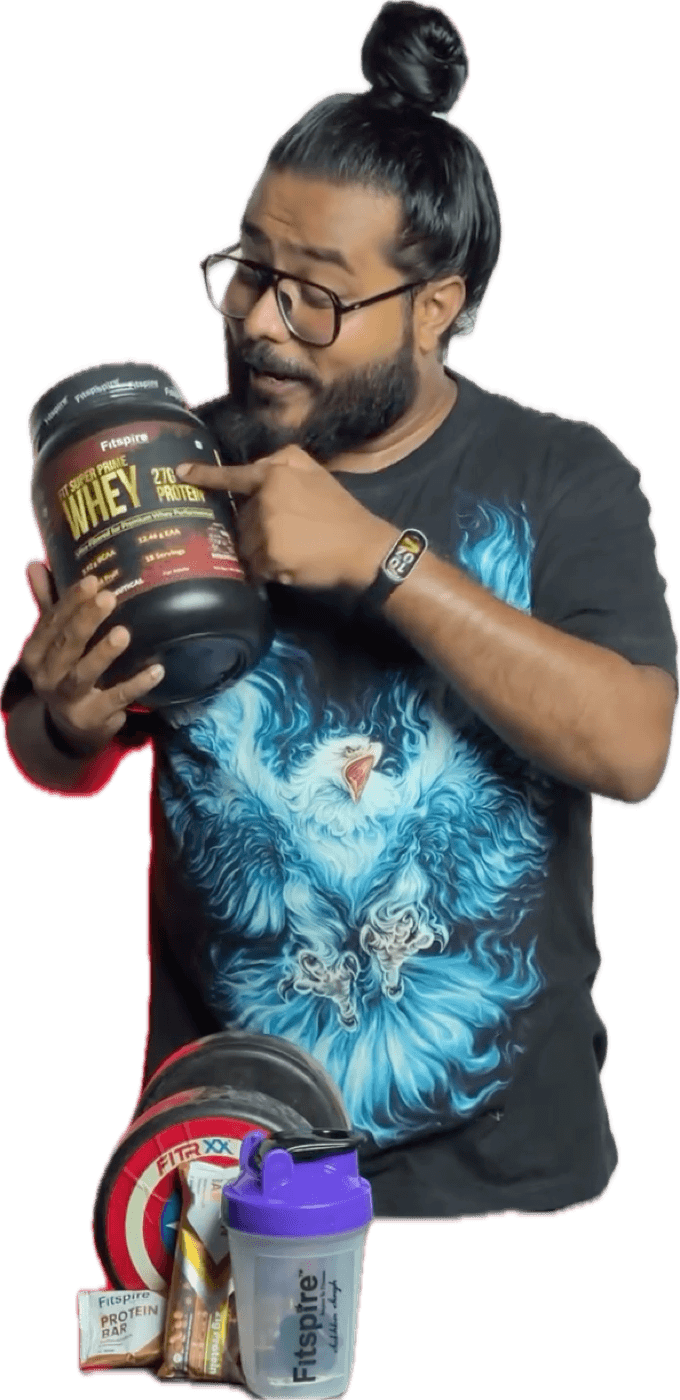 Akio with a Fitspire whey protein tub, a shaker, creatine and protein bars on a table