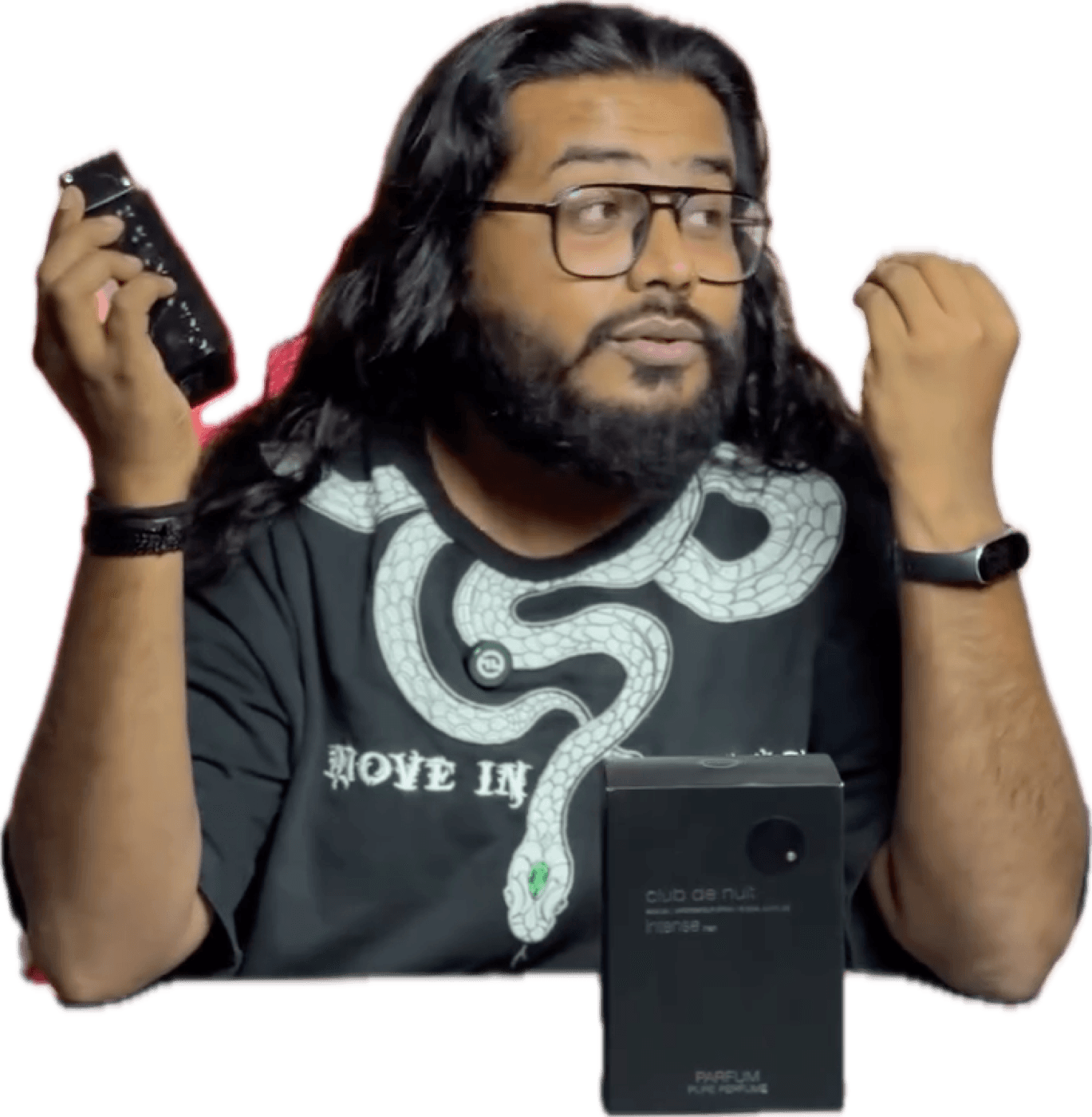 Akio holding a black bottle of Armaf Club de Nuit Intense Man Pure Parfum and its box